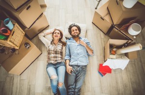 Young couple moving in into new apartment